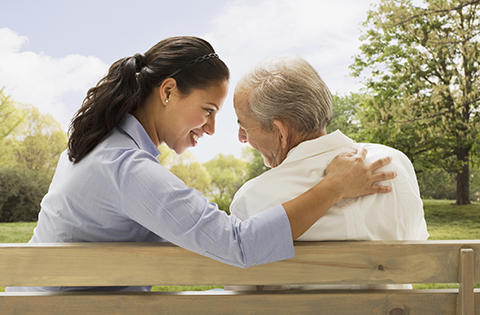 A woman with her arm around an older woman