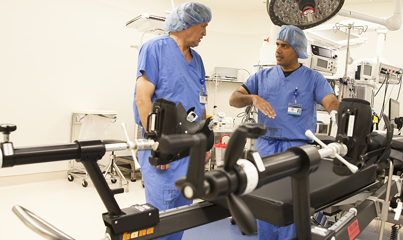 Two Doctors talking next to medical equipment