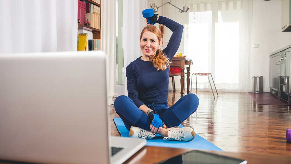 A woman lifting a barbell over her head