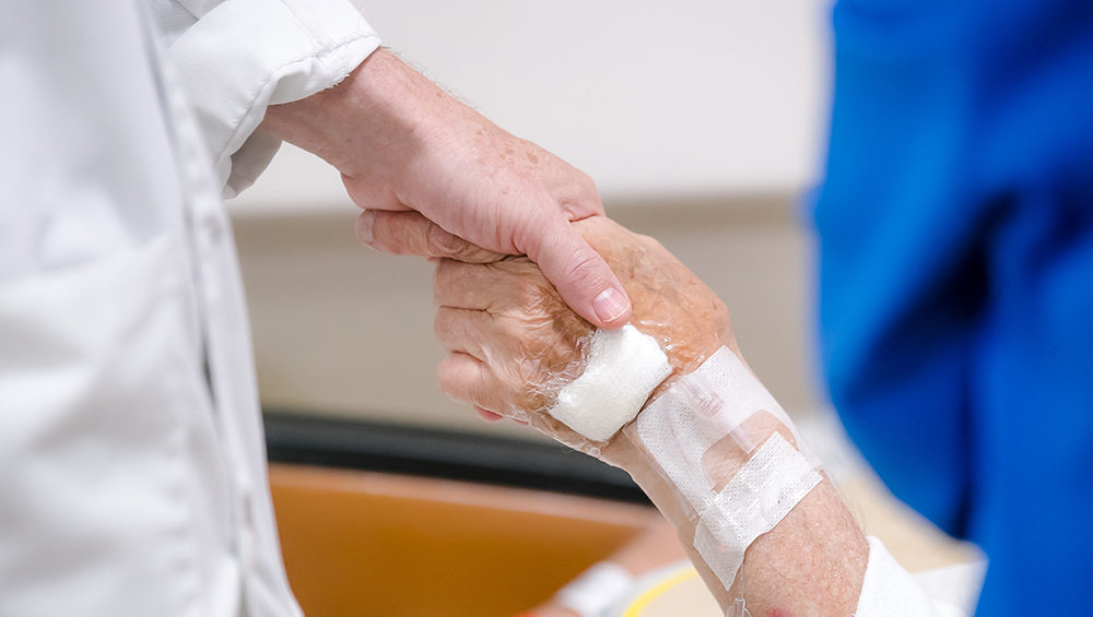 Doctor holding patient hand