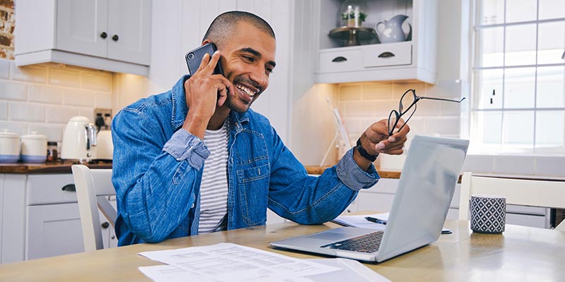man on laptop and phone