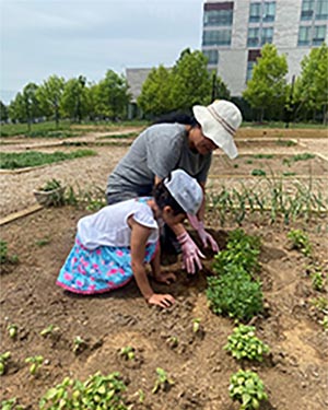woman and child planting